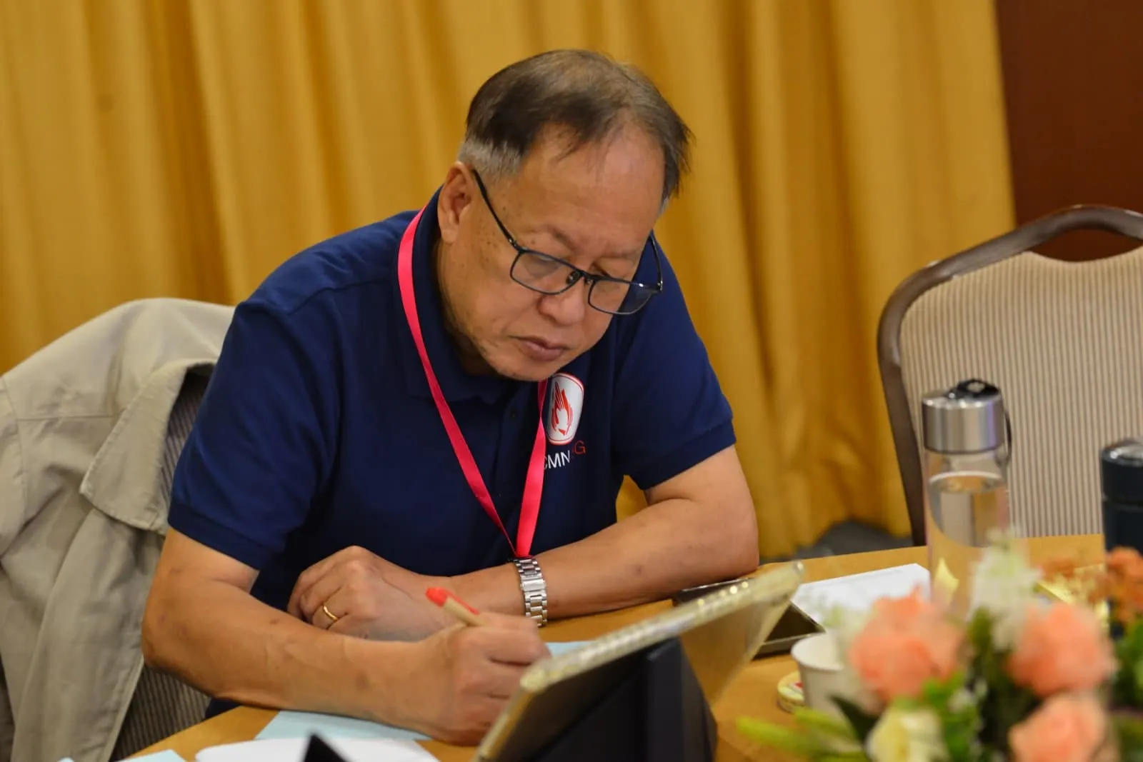 A member taking notes during a session