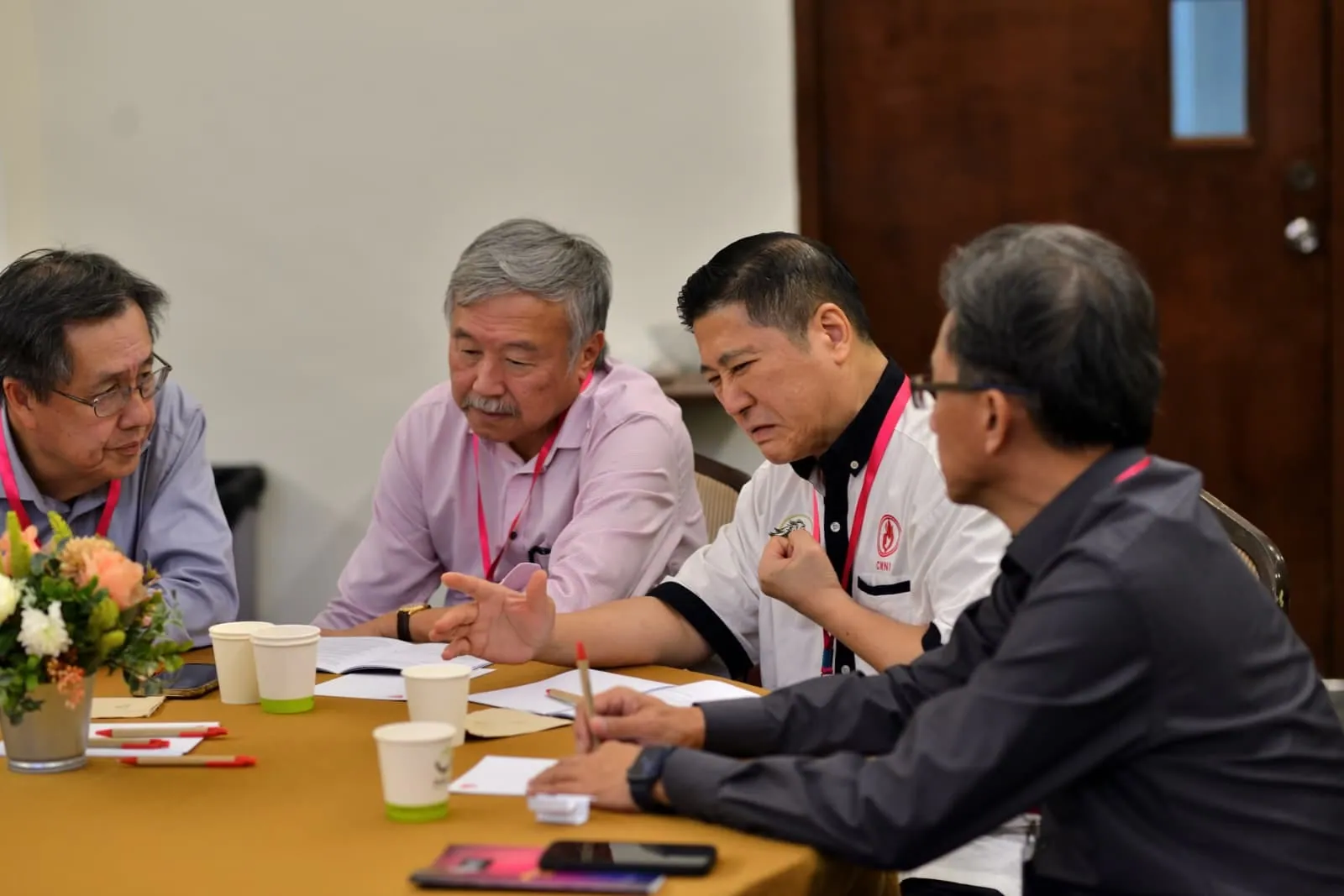 Members in conversation around a table