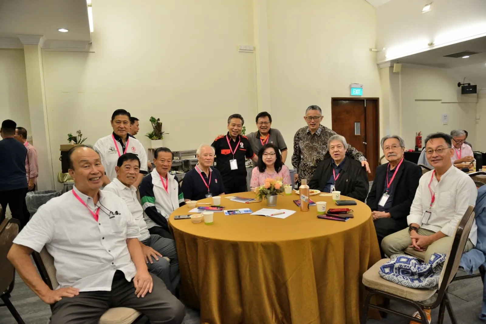Members smiling around a table at a fellowship meeting